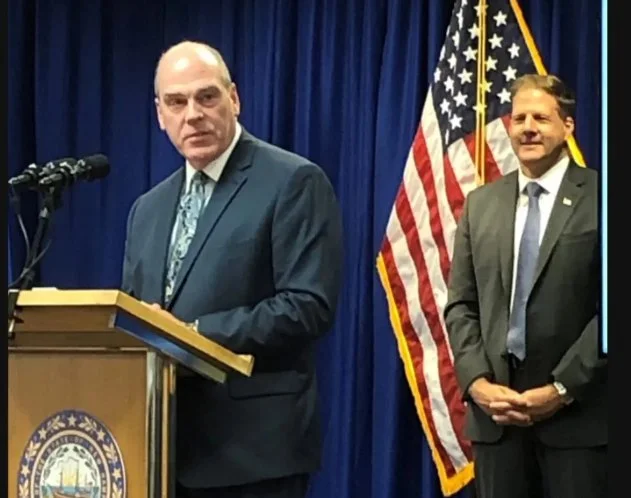 Perry Plummer speaking at a state government event with Governor Chris Sununu nearby